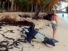Riding an inflatable whale at the beach - nonpop