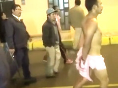 Cops walk a nearly naked criminal down the street