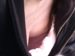 Sexy babe without a brassiere in the middle of the street