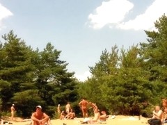 Naked people enloyong the sun on the beach