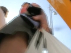Upskirt voyeur video of a brunette milf